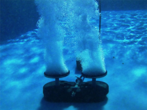 Underwater view of a Dual Disc Rubber Membrane Diffuser putting air into water.