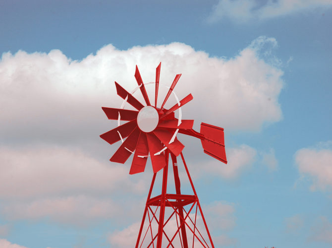A red and white background against a blue sky.