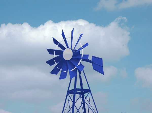 A blue and white windmill on a blue sky background.