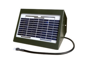 A 12 volt 2 watt solar charger on a white background in a green housing with an electrical wire coming off it.