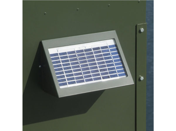 A small solar panel on a green cabinet.