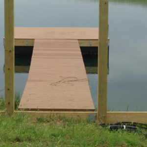 A wooden dock in a pond.