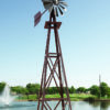 Full image of a Large Backyard Windmill in bronze with trees and a floating fountain in the background.