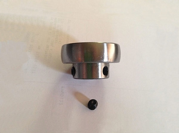 A silver colored fan replacement bearing with small black screw.