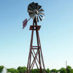Upward angle of a small bronze windmill against a blue sky.